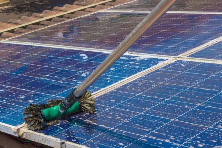 Cleaning solar panels on house roof Solar Energy Concept Image